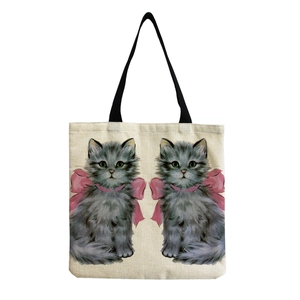 Detailed view of beige linen tote bag featuring cute symmetrical grey cats and pink bows