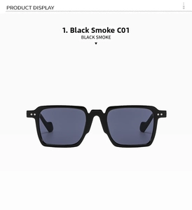 Detail of square black sunglasses with silver rivet accents and dark smoke lenses