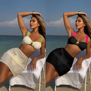 Contrast bikini set featuring gold ring detail and matching mesh sarong on a beach