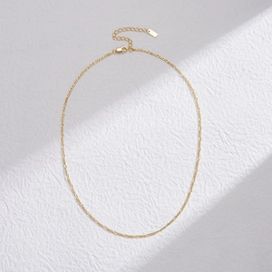 Close-up of S925 sterling silver gold Figaro chain with lobster clasp and purity stamp