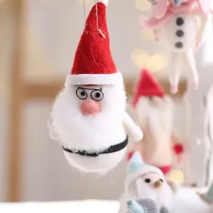 Handmade Christmas felt ornaments featuring Santa and snowman with cozy warm bokeh lighting