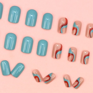 Short round press-on nails with blue finish and colorful wavy pattern on pink base