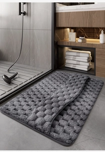 Detail of grey memory foam bath mat with embossed texture and non-slip backing
