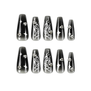 Press-on nails featuring black gradient, silver butterfly patterns, and rhinestones