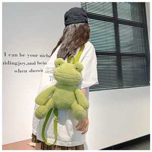 Rear view of a cute green frog plush backpack with adjustable straps on a model
