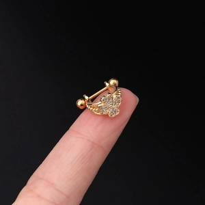 Macro view of golden butterfly stud earring with clear zircon inlay and screw ball back