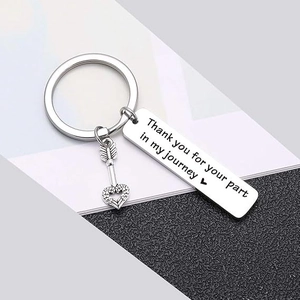 Detailed macro of stainless steel keychain with engraved quote and heart arrow charm