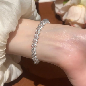 Close-up of elegant double-layer beaded bracelet with pearls and crystals on wrist