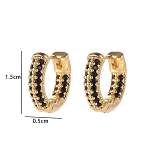 Detail view of gold earrings with black micro-pave stones and 1.5cm by 0.5cm dimensions