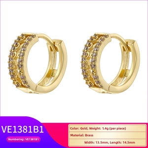 Detail of gold double layered hoop earrings with micro-inlaid cubic zirconia stones