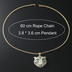 Detail view of gold lion head pendant with green eyes and 60 cm rope chain necklace