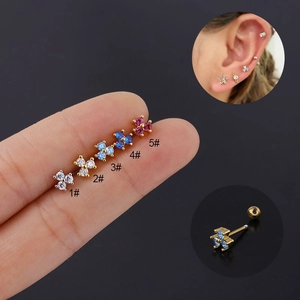 Macro detail of five colorful flower zircon cartilage studs on finger with screw ball back
