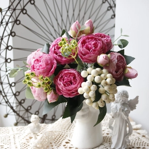 Elegant pink silk peony and white berry bouquet in a minimalist vase for home decor