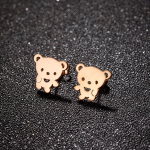 Polished rose gold teddy bear stud earrings for women on a black glitter background