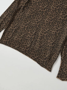 Close-up of leopard print knit top showing ribbed hem and sleeve cuff texture
