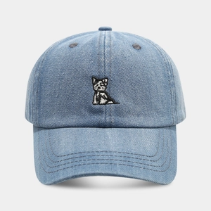 Close-up of cute dog embroidery on light blue washed denim baseball cap with fine stitching