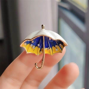 Starry umbrella brooch in gold metal with colorful enamel and sparkling rhinestones