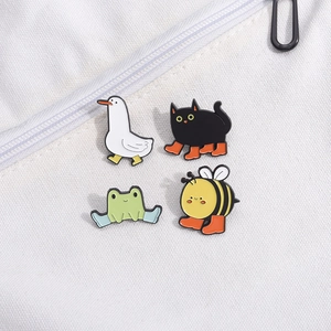 Set of four cute enamel pins featuring a white duck, black cat, green frog, and a honey bee