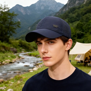 Navy blue breathable mesh baseball cap with metal SPORTS logo in outdoor mountain setting
