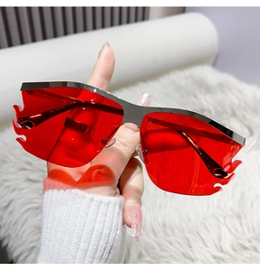Detail view of flame-shaped red lenses with frameless silver metal edges for street style
