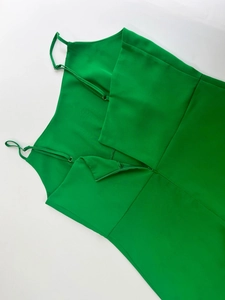 Detail of adjustable thin straps and invisible zipper back on bright green floral dress