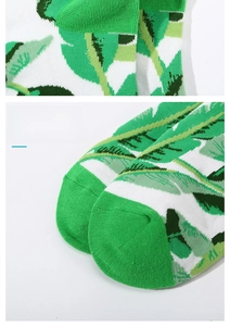 Detail view of cotton blend socks with green leaf patterns and flat seamless toe closure