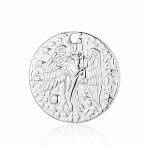 Macro detail of silver stainless steel angel wing relief pendant with mirror reflection