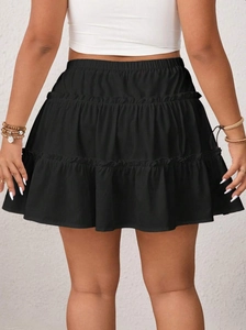 Rear view of a black multi-layered tiered mini skirt with elastic high waist for women