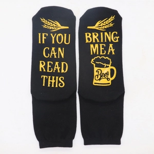 Detail of cotton socks with yellow beer embroidery and funny text on the soles