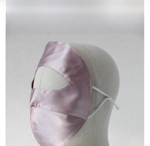 Detail view of pink 100% silk sun mask on a mannequin showing breathable knitted texture