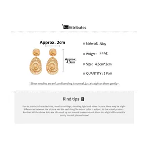 Detail view of gold alloy spiral shell earrings showing dimensions 4.5cm by 2cm size