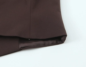 Detailed view of dark brown suit jacket stitching and silky diagonal twill lining fabric