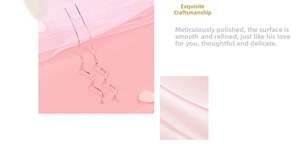 Detailed view of elegant S-shaped wave long drop earrings in polished silver metal