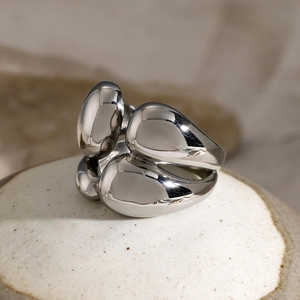 Macro shot of polished silver stainless steel double-layer fluid pebble-shaped ring