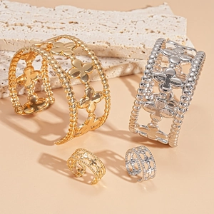 Chic clover cutout open cuff bracelets and rings set in gold and silver metal finishes
