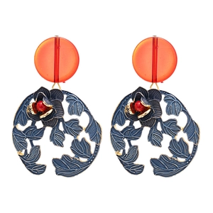 Retro earrings with orange resin beads and blue hollow metal floral discs in gold trim