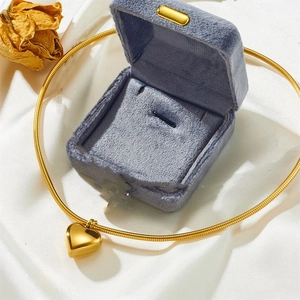 Gold hollow heart pendant stainless steel necklace displayed on white silk with gift box