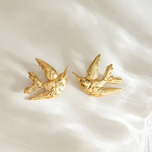 Boucles d'oreilles oiseaux en acier doré poli avec détails de plumes délicats