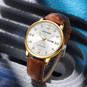Close-up of luxury golden watch dial with diamond markers and brown leather strap