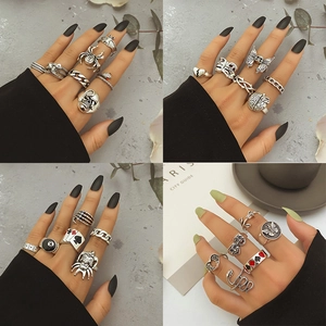 Gothic punk silver ring set featuring skull, spider, and snake designs for a retro aesthetic