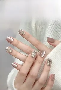 Macro view of short press-on nails featuring sparkling glitter and luxury rhinestones
