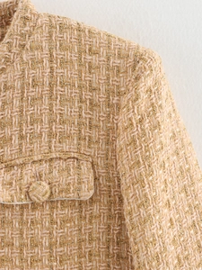 Detailed macro shot of luxury champagne gold tweed fabric with metallic gold thread texture