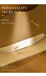 Detail of gold S925 silver necklace with rectangular pendant and three zircons