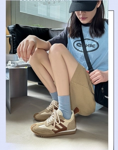 Detail of retro sneakers with brown suede patchwork and gum outsole for women