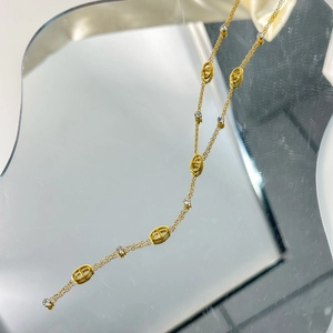 Detail of 18K gold-plated necklace featuring pig nose links and sparkling zircon stones