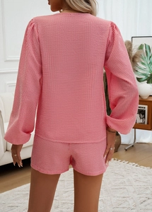 Dettaglio del set pigiama a righe bianche e rosa in tessuto stropicciato seersucker