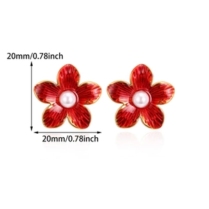 Detailed size view of red floral stud earrings with white pearl center and gold finish