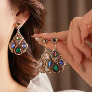 Vintage bohemian teardrop earrings with colorful crystals and emerald green stone