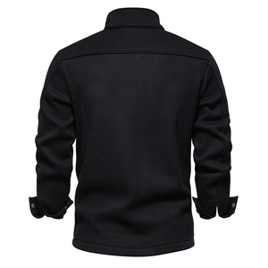 Macro detail of black waffle knit texture on men's winter jacket with ribbed cuffs