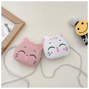 Close-up of cute cartoon cat coin purses in pink and white with silver braided straps